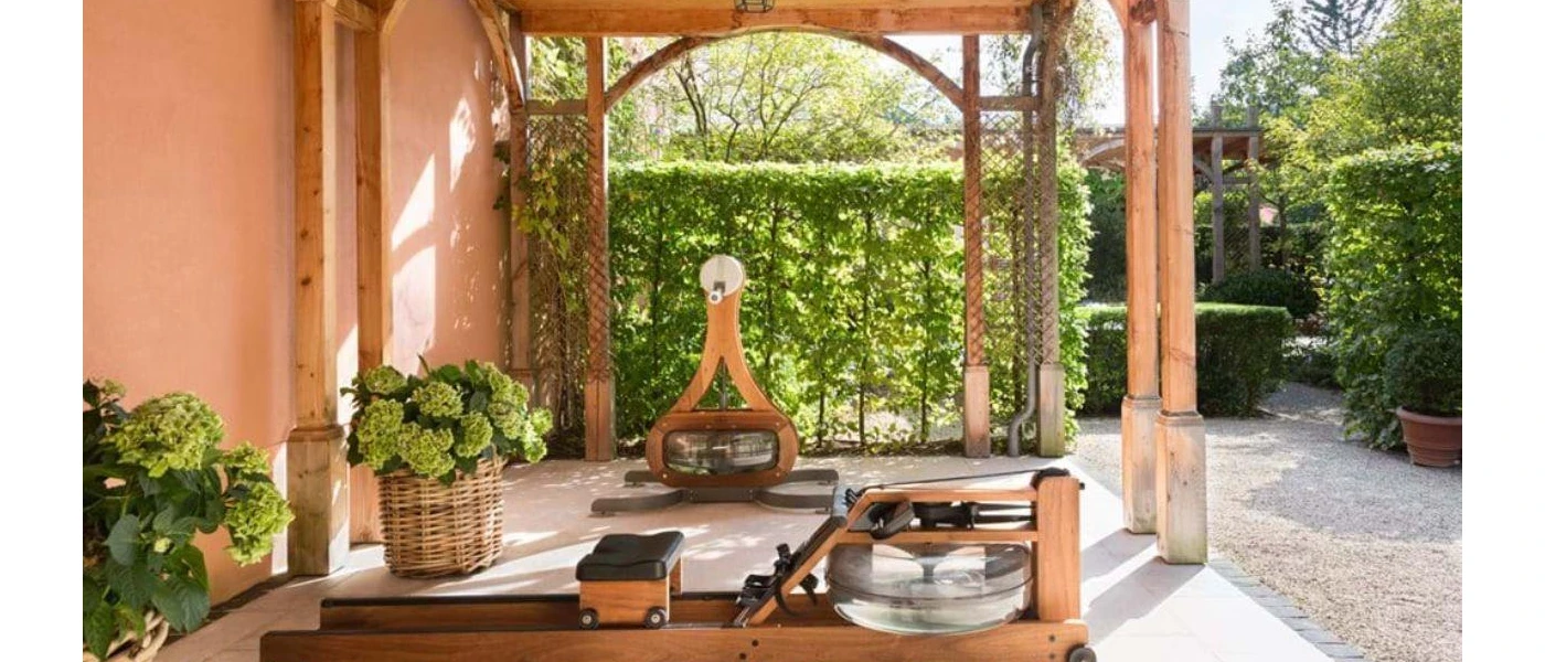 Leafy outdoor wooden pagoda with wooden fitness equipment and potted shrubs