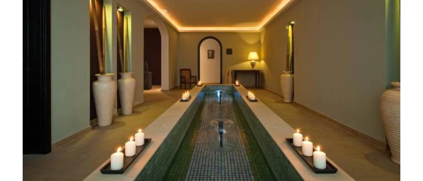 Tranquil spa treatment room at Hacienda del Conde, Tenerife, softly lit with glowing candles creating a serene ambiance