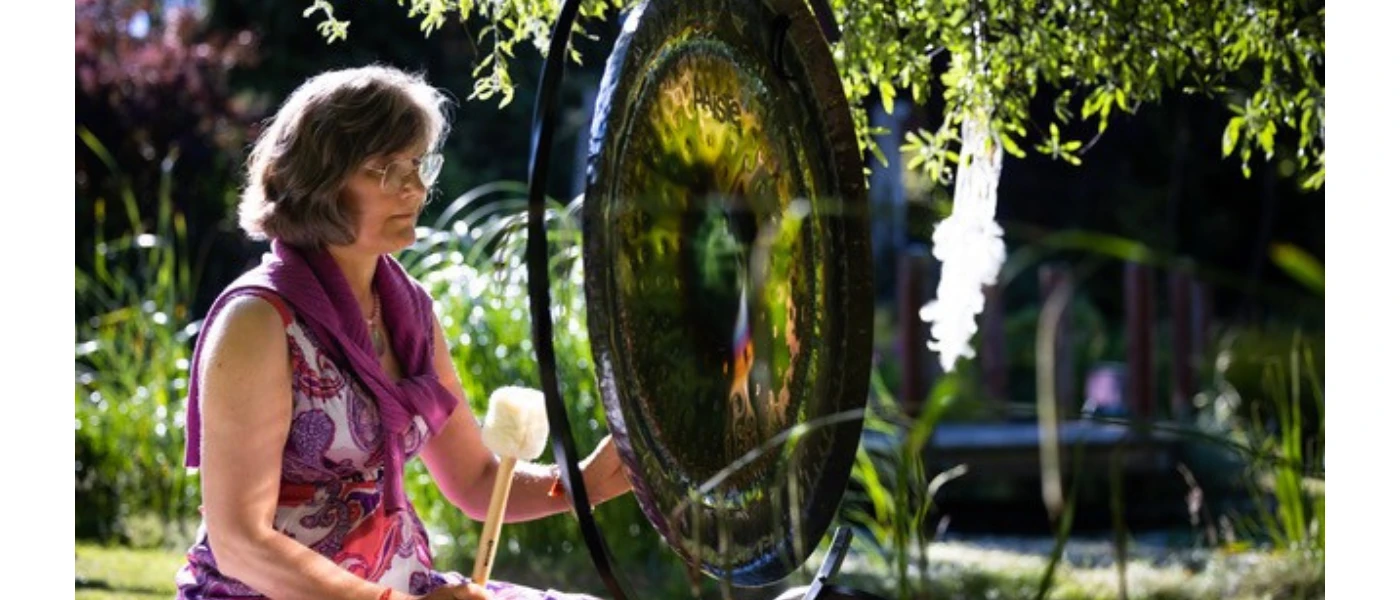 Claudia Roth performing Gong Bath sound healing outdoors