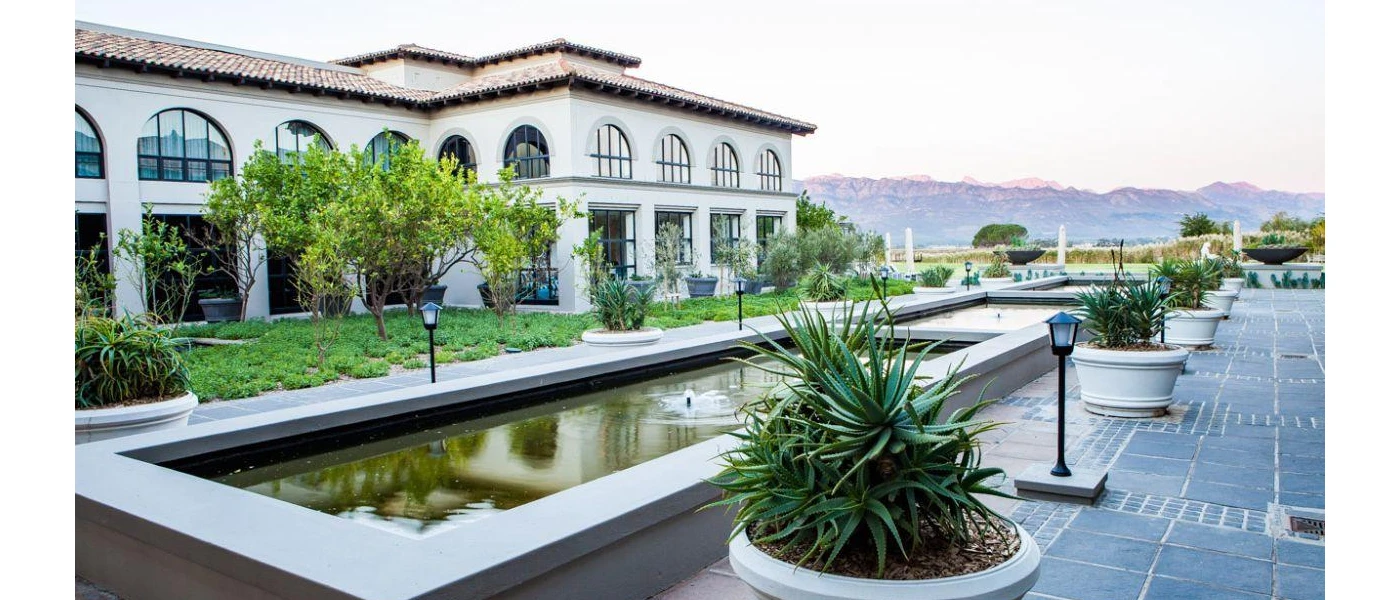 Concrete-framed ponds outside SANté Wellness Retreat & Spa, fringed by white plant pots and black lighting
