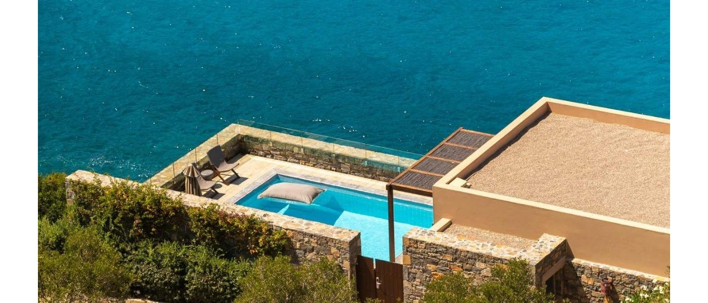 Low-rise villa with a seafront perch, with a private pool terrace, loungers and cobble-stone walls