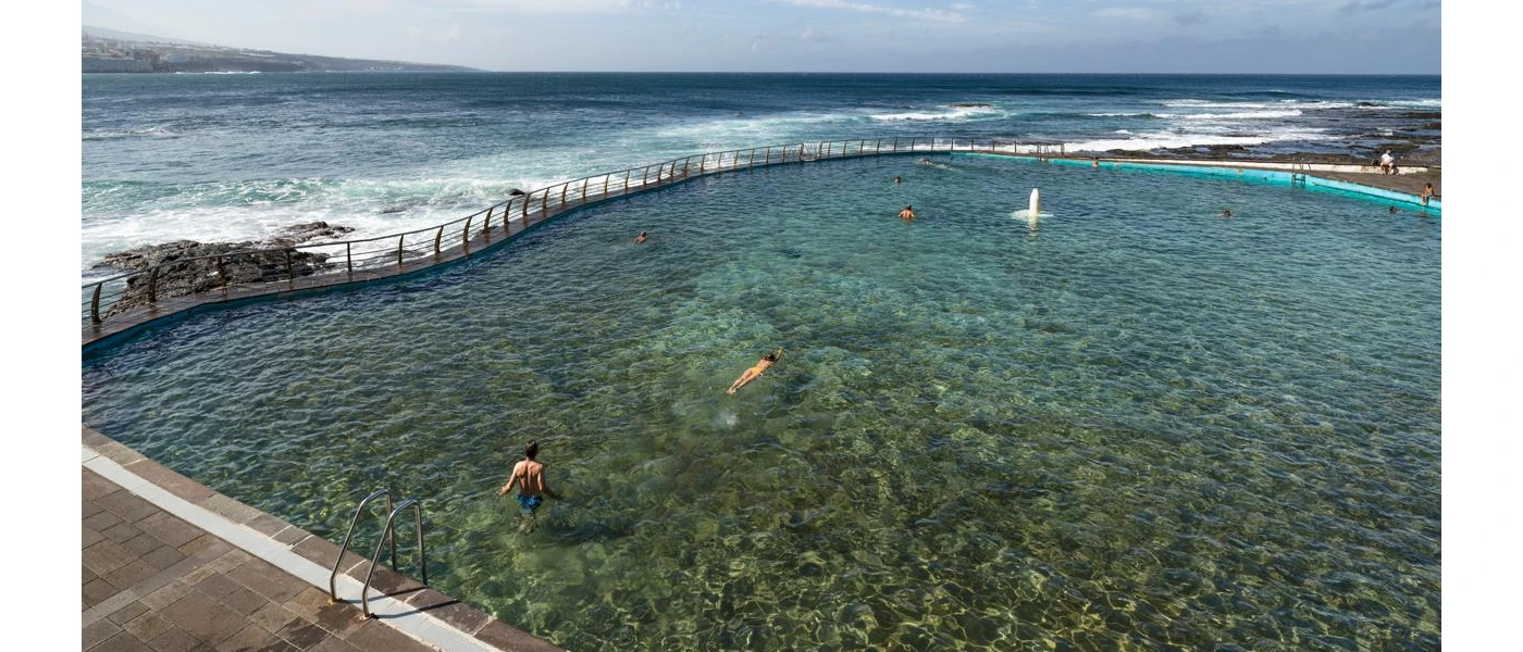 A seawater swimming pool as ocean waves crash against it