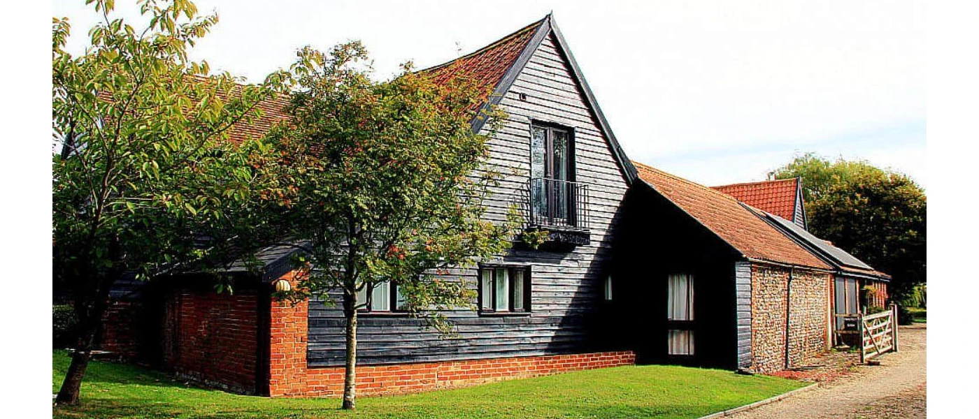 Black wooden exterior of The Detox Barn, Suffolk wellness retreat 