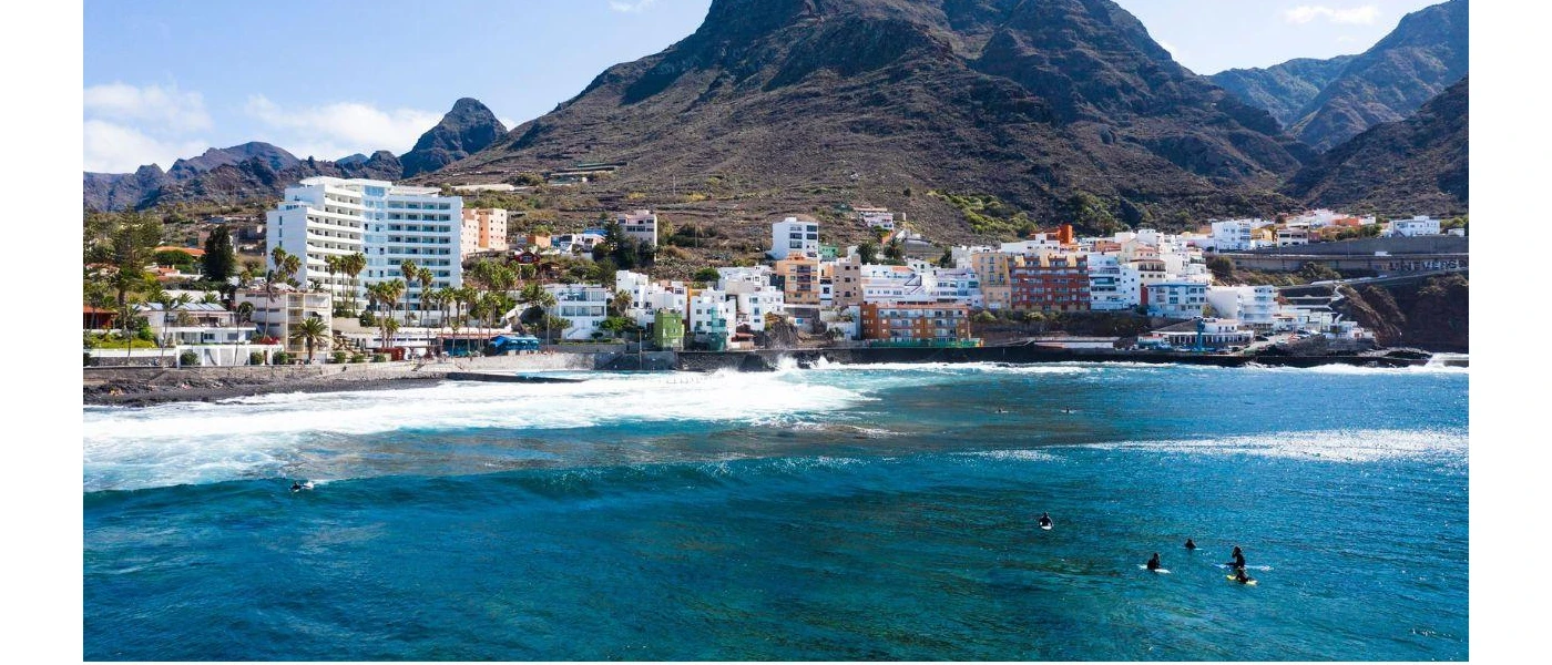 Mount Teide with buildings below and the Atlantic Ocean
