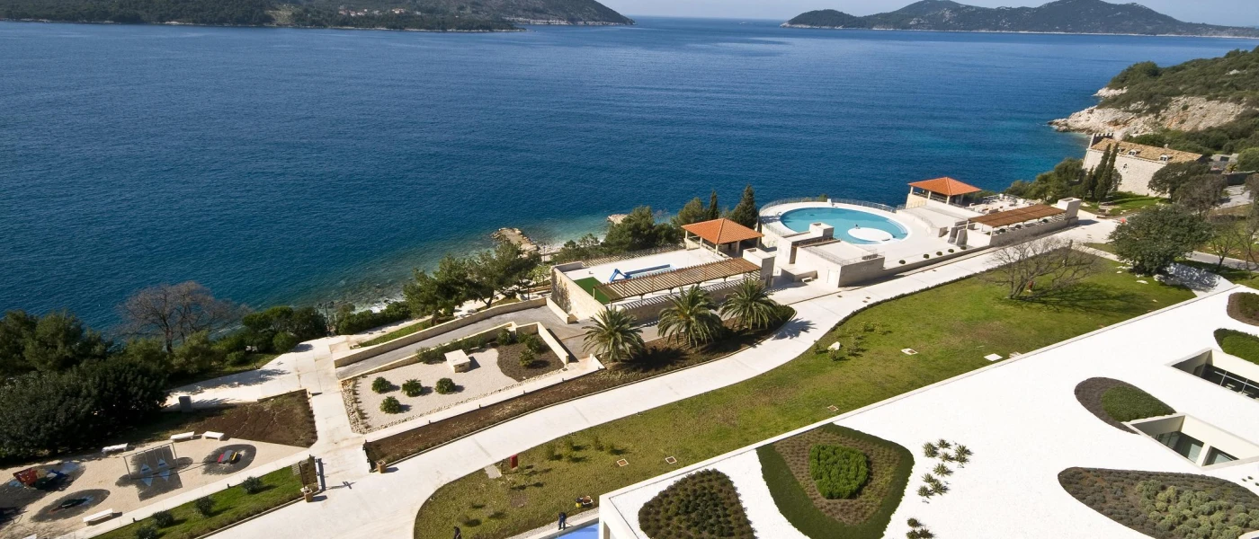 Aerial view of landscapes grounds, with grass lawns and swimming pools overlooking the Adriatic Sea