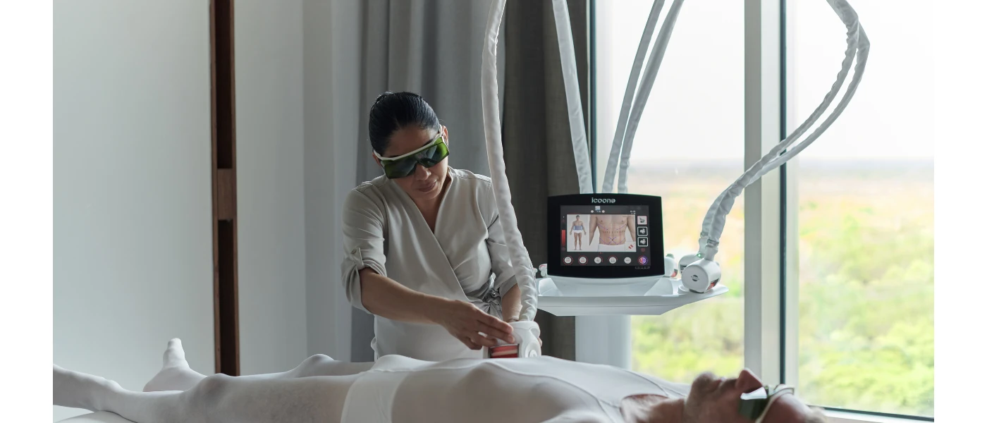 An expert scans a man's stomach as he lies down and images appear on a screen behind