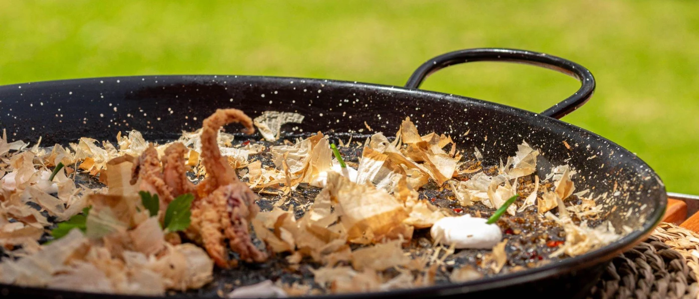 Large black pan with squid at the centre 
