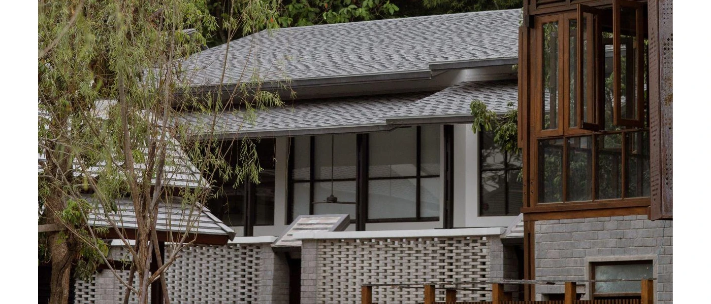 Grey tiled rooftops and teak panelling on low-rise buildings