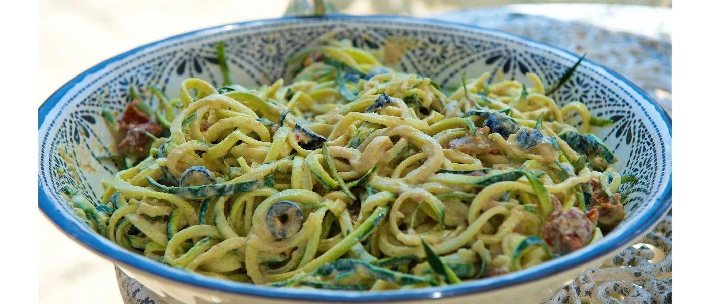 Bowl of pasta with vegetables and a creamy sauce