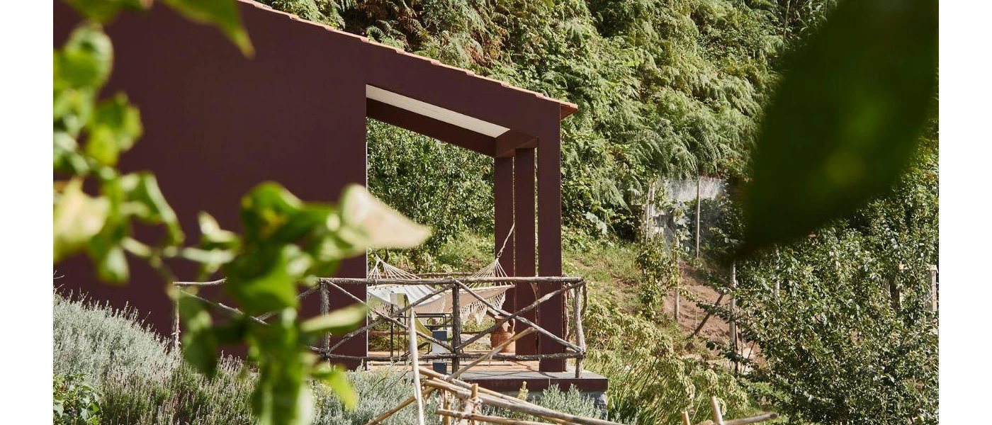 Wooden terrace among greenery with a hammock