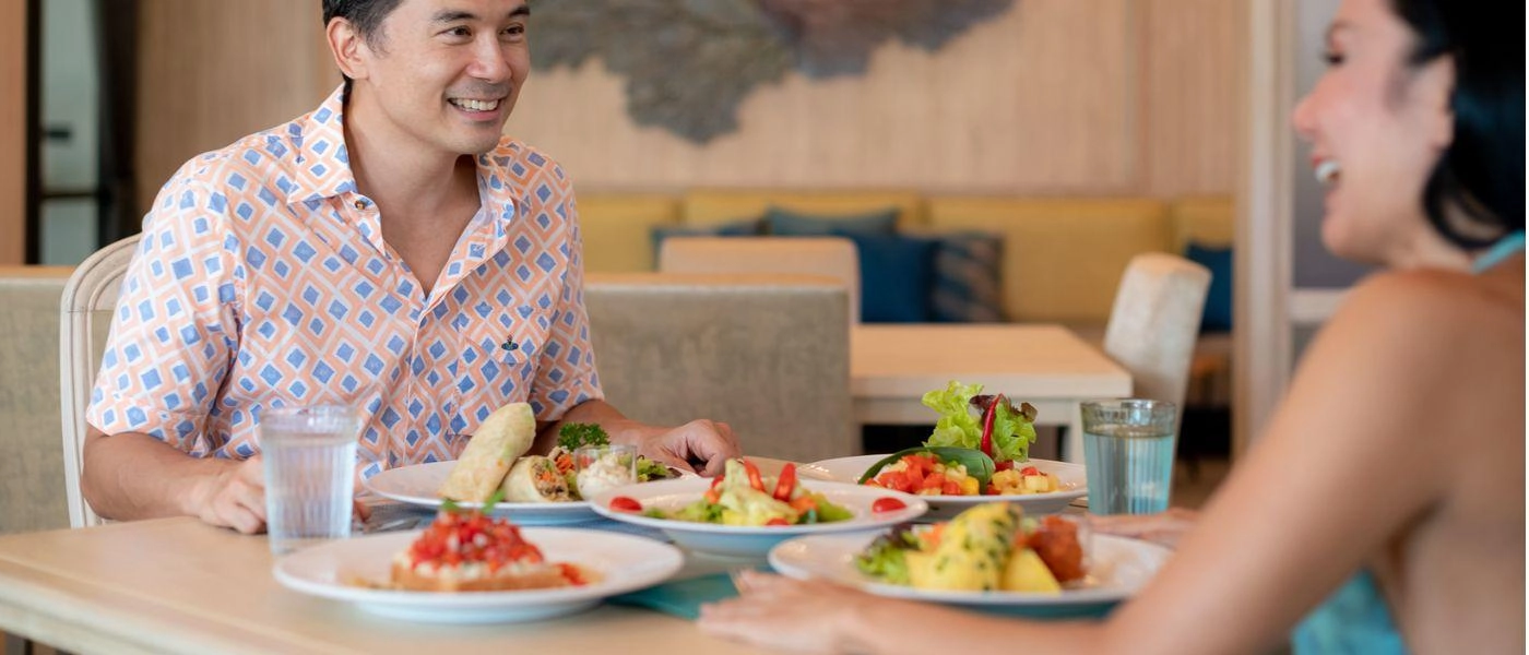 Couple eating tasty and healthy looking meal and having a good chat