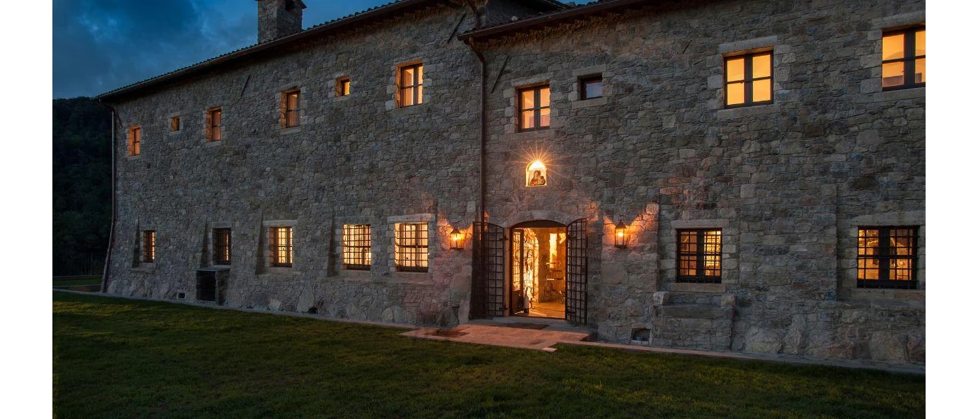 Cobbled stone building lit by candlelight after dark
