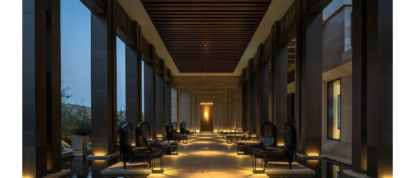 Dark, atmospheric terrace with pillars, armchair-style seating and low lighting