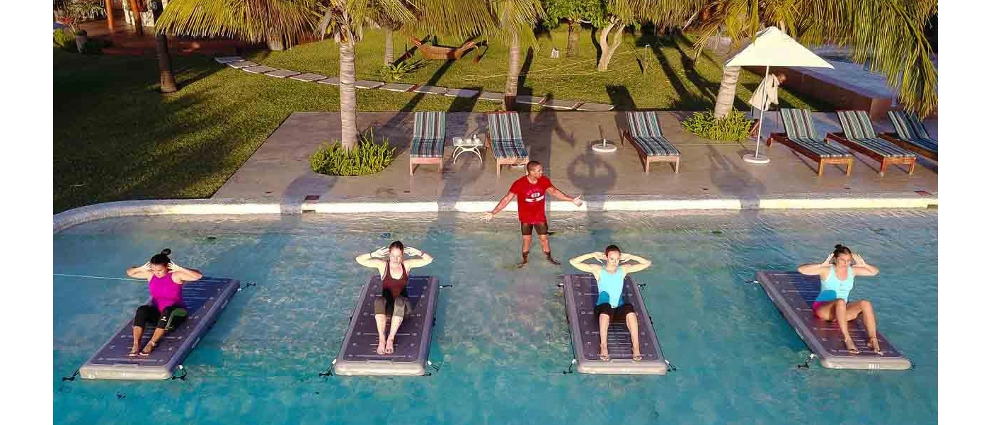 Group in active wear in a sit up position while an instructor oversees