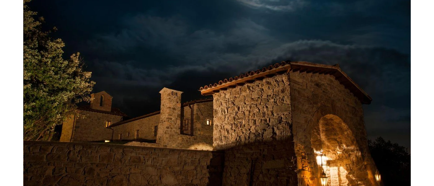 Cobbled stone building lit by candlelight after dark