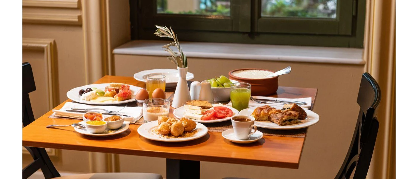 Restaurant table set for breakfast with various breakfast items 