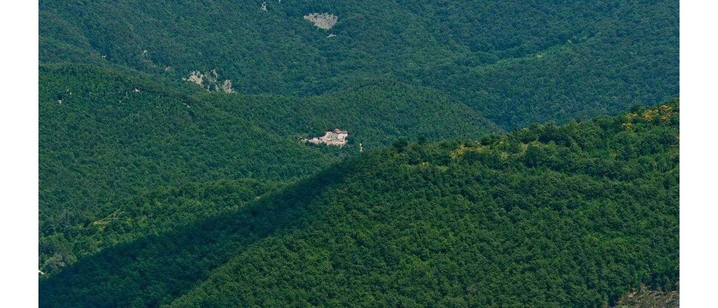 Historic building surrounded by hills thick with greenery