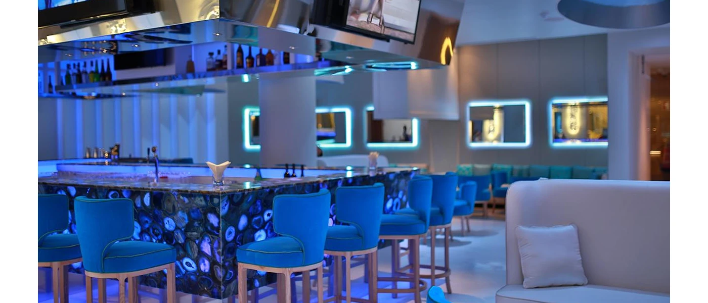 Central bar with blue lighting, blue stalls and a blue mural design