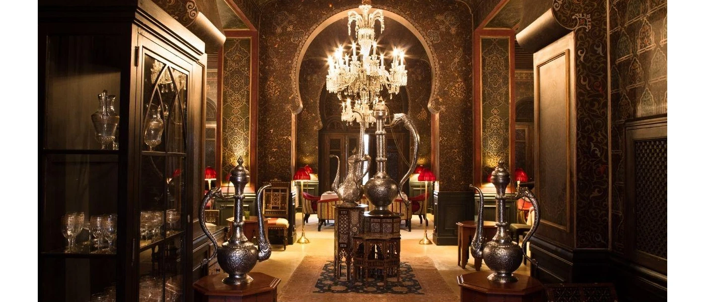 Arabic-style lounge with silver lamps, a chandelier and seating