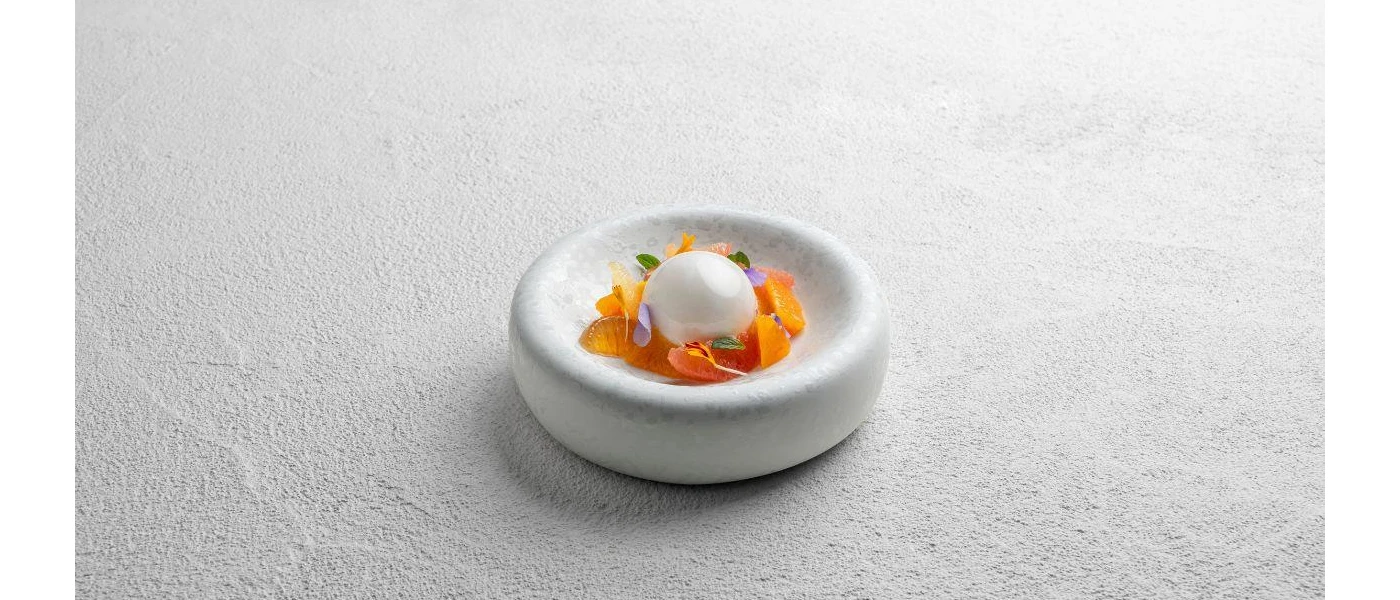 Dessert with edible flowers on a small white plate