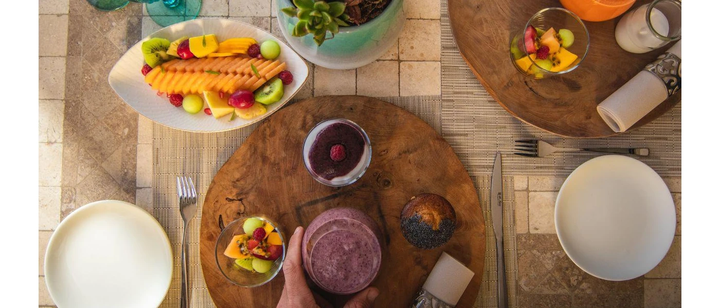 Bowls of fruit on a table laid out for breakfast