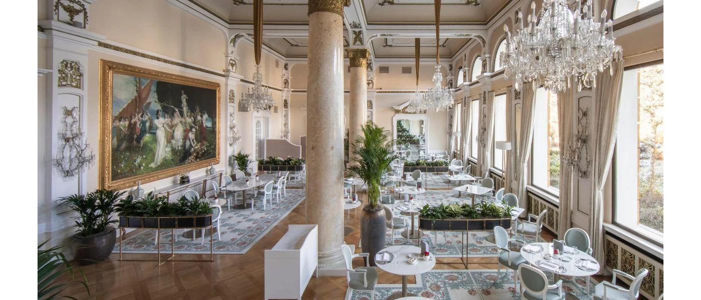 Newly refurbished restaurant with grand glittering chandelier and dinner set up