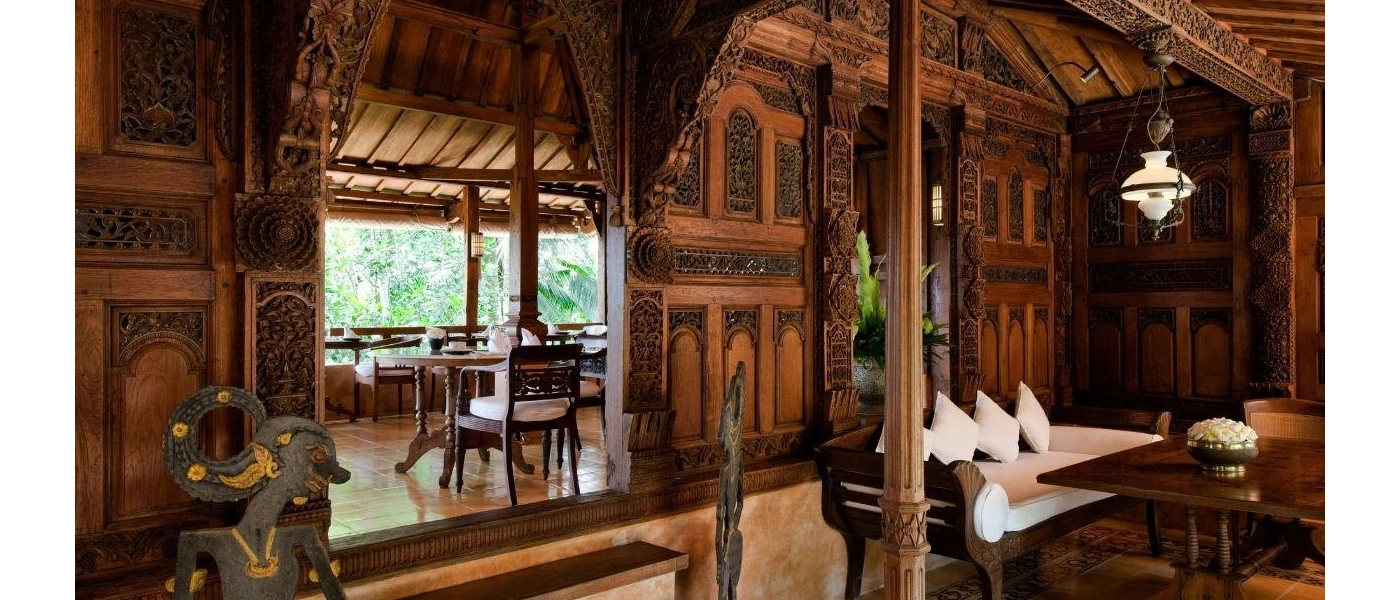 Restaurant with beautiful wood walls with intricate carvings and lanterns suspended from the ceiling