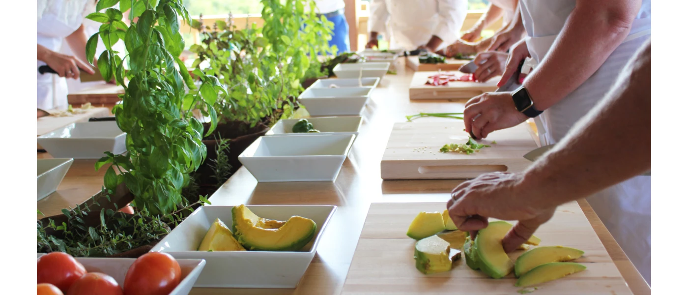 Group healthy cooking class with numerous people preparing nutritious meals together