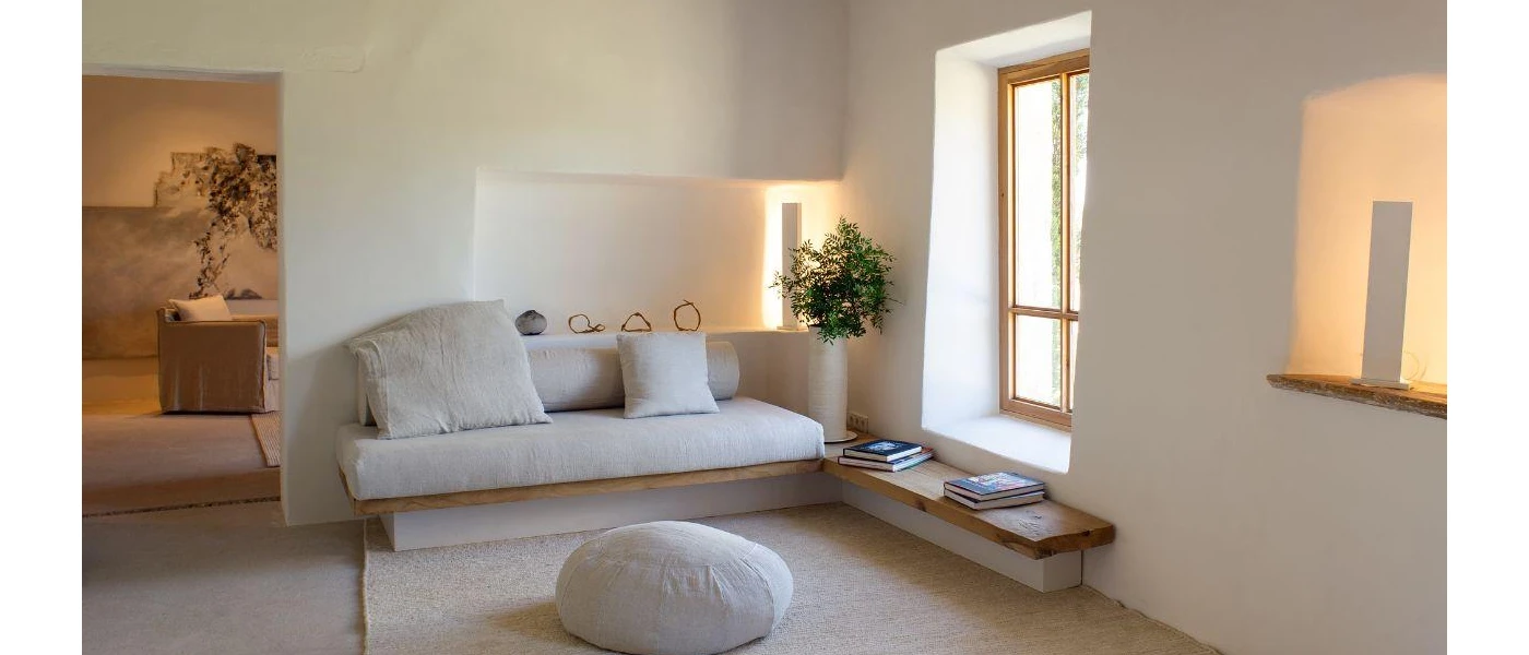 Neutral colour sofa and footstall in a cosy softly lit seating area