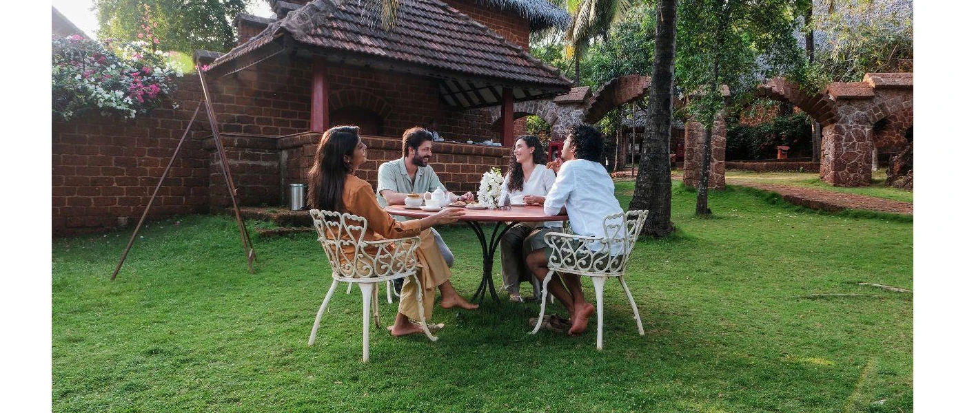 Geust socialising and having fun together around a table in the outdoor restaurant 