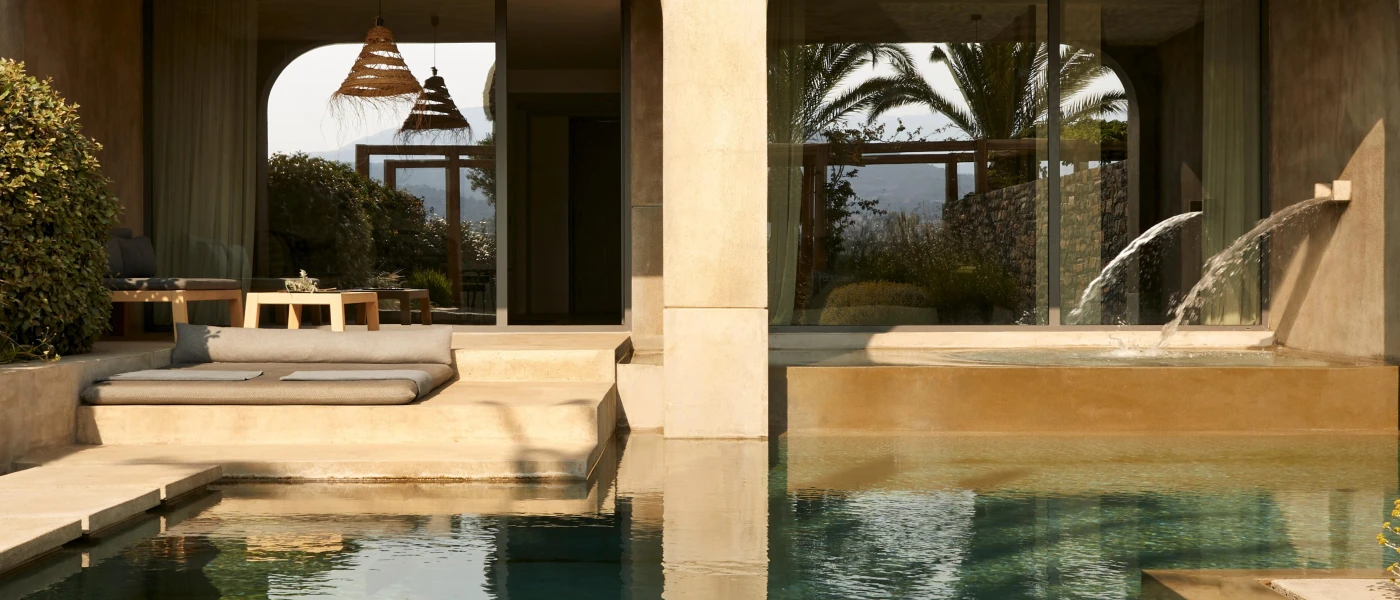 Villa terrace with neutral furniture, a rattan ceiling pendant light, and a pool with jets