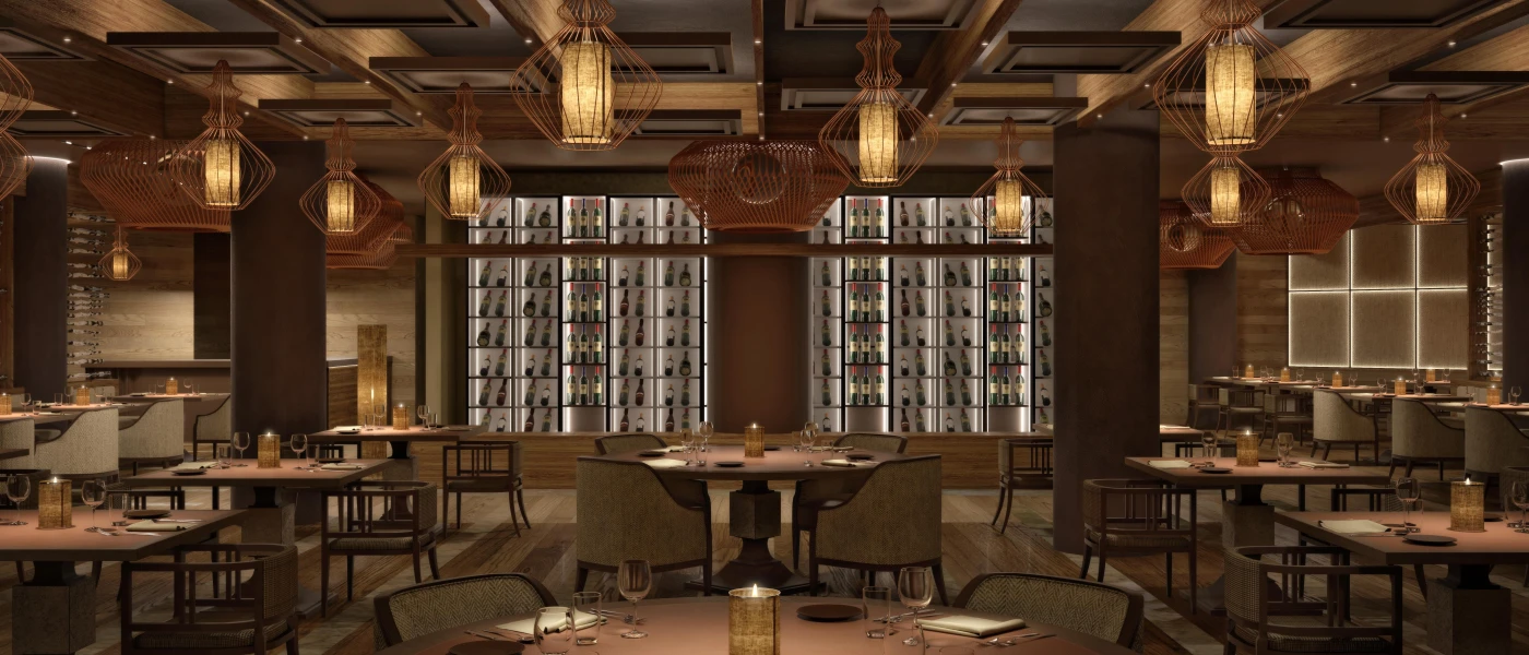 Softly lit restaurant with lantern-style pendant lights, a wall stacked with wine bottles and wooden tables and chairs