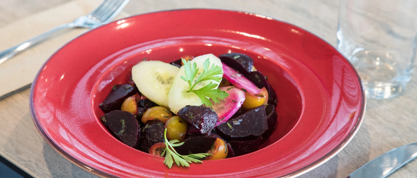 Beautifully presented vegetables in a red bowl