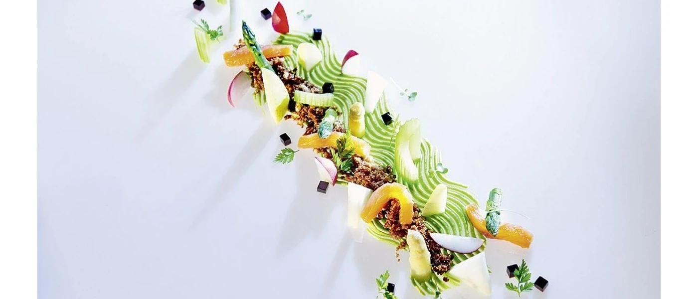 Asparagus stem on a green jus, coated in mince and vegetables