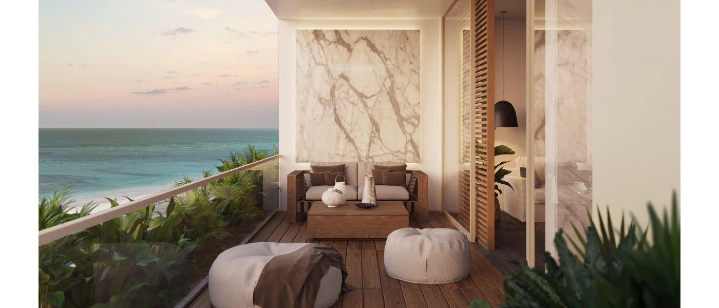 Balcony with dark-wood decking, a marble design on the wall, a wooden cushioned sofa and coffee table and beige bean bags