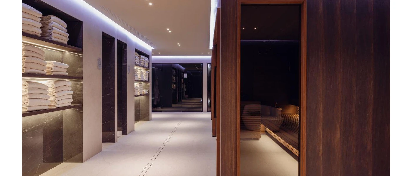 Indoor spa facilities featuring sauna and racks with clean towels 