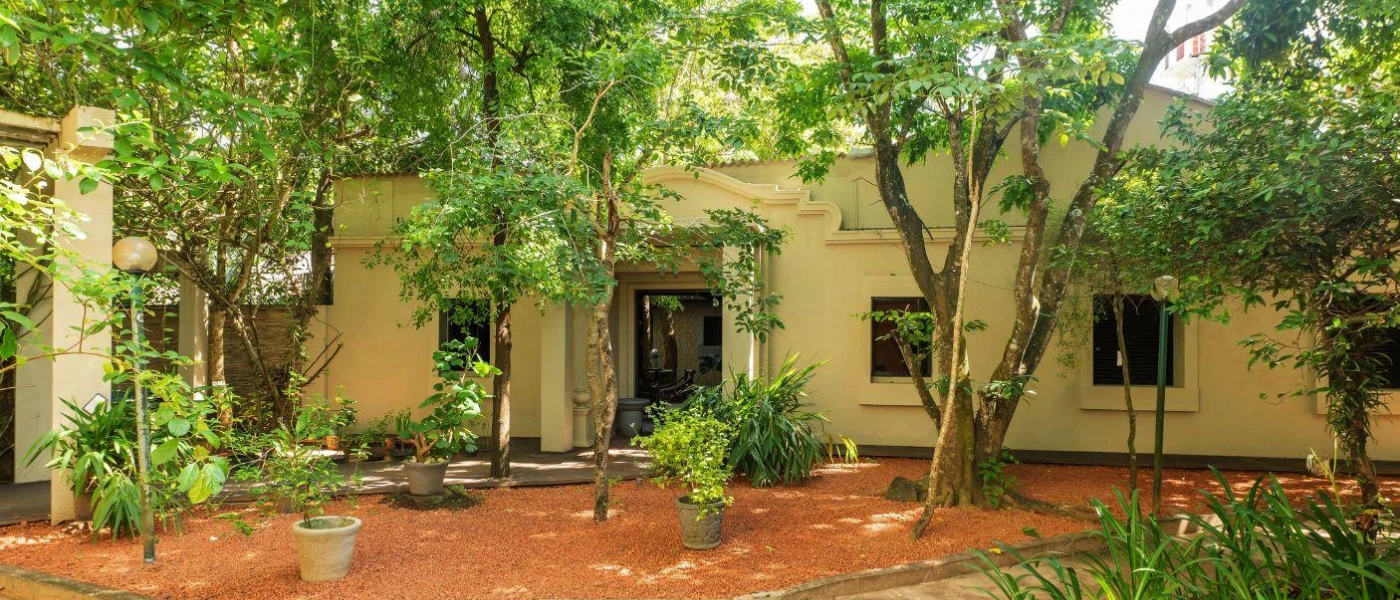 Cream accommodation block fringed by trees