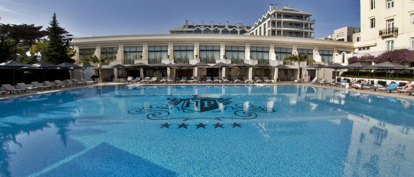 Large swimming pool with an HP emblem at the bottom, standing for Hotel Palacio