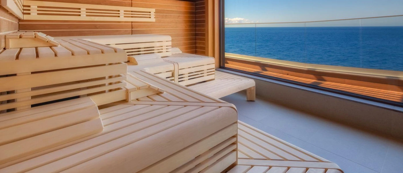 Wooden sauna with a large sea-view window