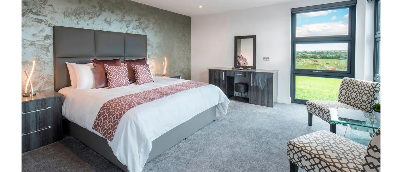 Stylish hotel room with grey, blush and taupe tones