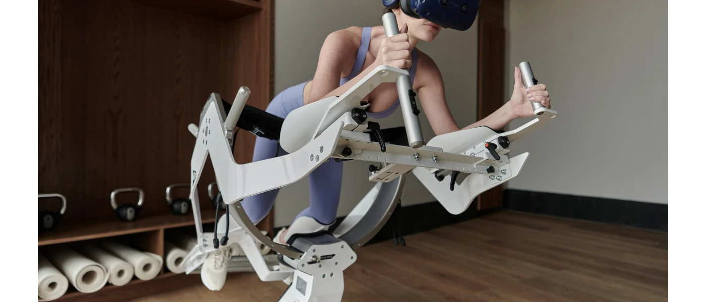 Woman in a virtual reality headset stands in a machine with space for her arms and legs