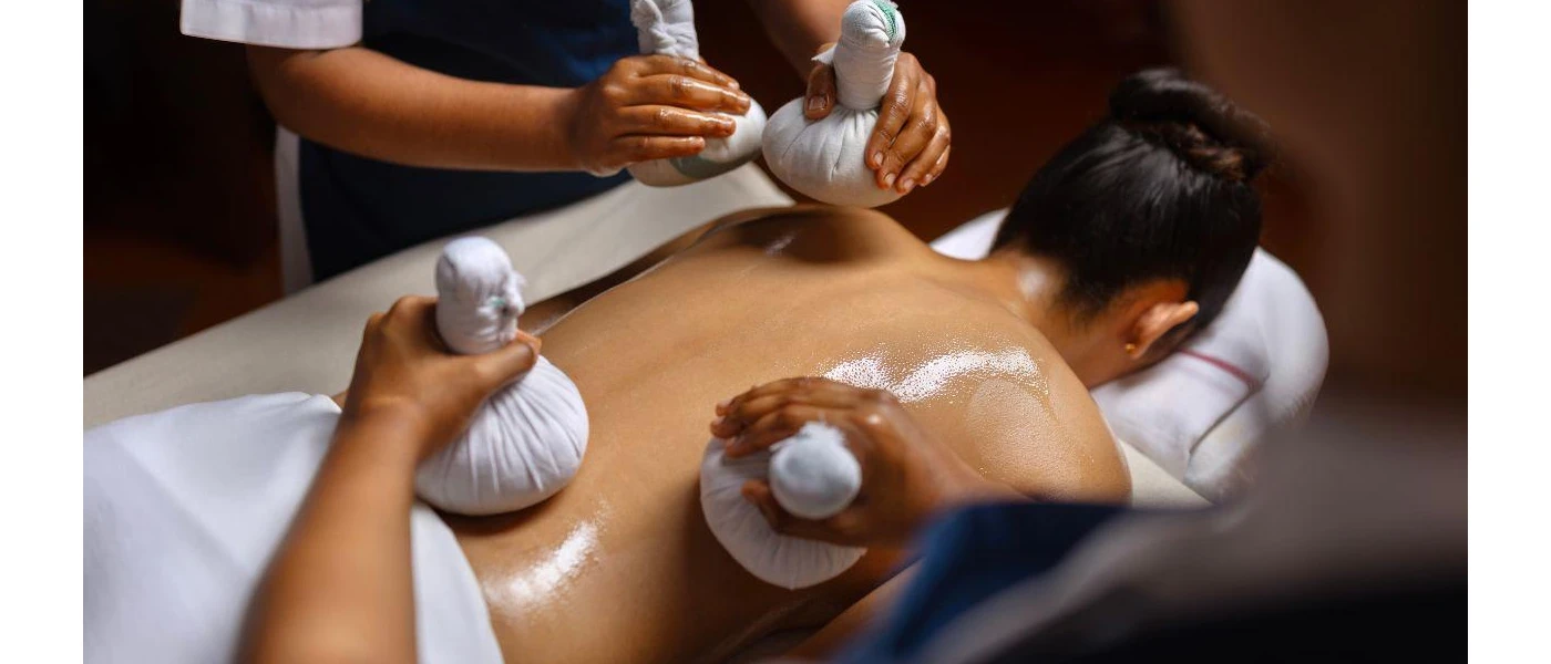 Four hands ayurvedic massages using Ayurvedic oils and herbal pouches