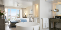 Luxury suite at Body Holiday with freestanding bath and ocean view.