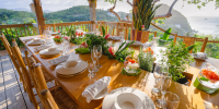 Open-air dining terrace at BodyHoliday St Lucia overlooking tropical hills and Caribbean Sea