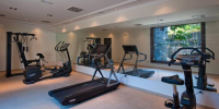 Modern, well-equipped gym at Hacienda del Conde, Tenerife, featuring cardio machines, weights, and spacious workout areas