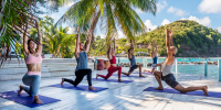 Group Pilates class on the beach at Body Holiday, Saint Lucia.