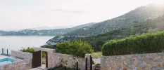 Cobbled walls, green hills, the Aeagean Sea and the corner of a swimming pool