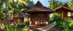 Little wooden huts with tiled rooftops and wooden terraces with a hammock in front, surrounded by tropical gardens