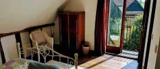 Bedroom with vintage furniture and a view of the sunny garden