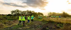 Group in high-visibility vests walking in the countryside